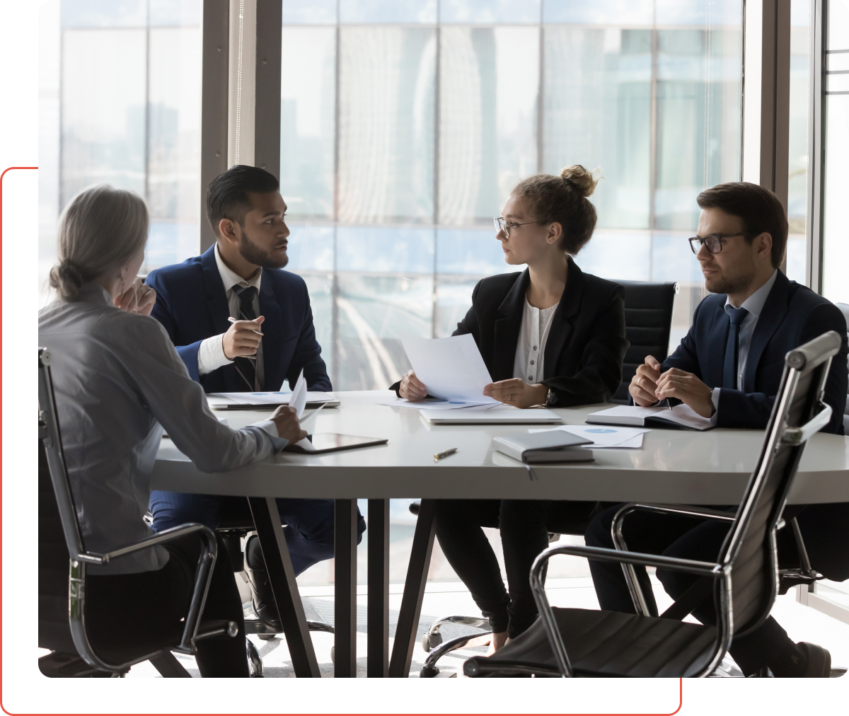 A group of people sitting at a table talking to each other.