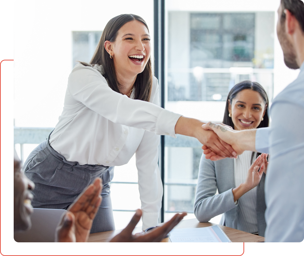 Group 13 A group of people shaking hands in an office.